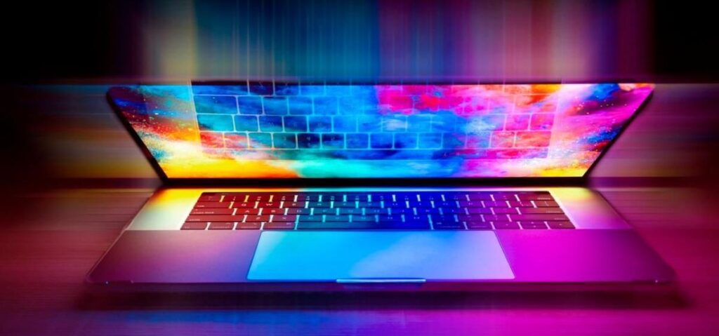 A laptop with a colorful background on the screen.